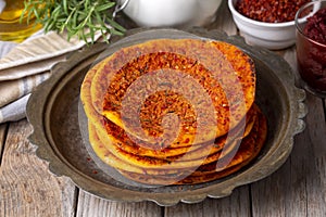 Traditional Turkish Biberli Ekmek Ã¢â¬ÅFlat bread with red pepper pasteÃ¢â¬Â being prepared before cooking in Antakya Hatay, Turkey photo
